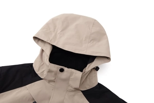 Close-up of hiking jacket hood with adjustable drawstrings and durable metal buttons