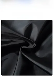 Detail view of 100% polyester fabric showing the durable, wrinkle-resistant texture