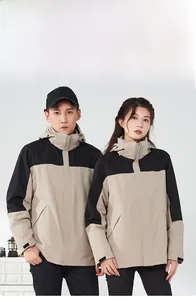 Detailed view of khaki and black 3-in-1 waterproof hiking jacket on male and female models