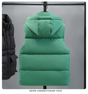 Detail view of green hooded puffer vest back with horizontal quilting for winter