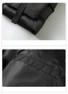Detail of the woven ribbon hem and functional hidden inner pocket on the black vest