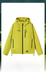 Detail of yellow waterproof outdoor jacket featuring windproof sealed zippers and hem drawstring