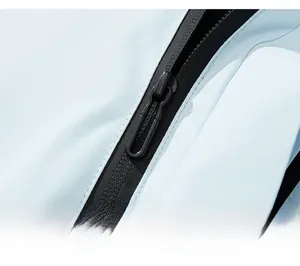 Close-up of waterproof black zipper on light blue outdoor jacket with premium finish
