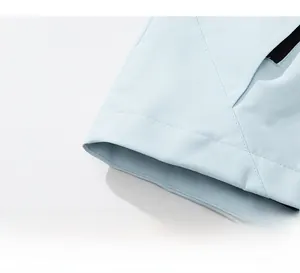 Detail view of the light blue outdoor jacket hem with precise double-needle stitching