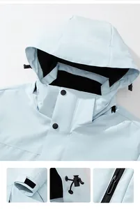 Detail of light blue windproof outdoor jacket featuring adjustable velcro cuffs and drawstrings
