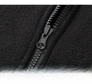 Detailed macro view of the smooth resin zipper and thick black fleece lining texture