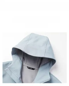 Detail view of the light blue hooded jacket featuring internal size label and grey rib lining