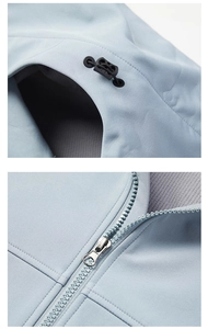Detail of light blue jacket featuring adjustable black cord locks and smooth resin zipper