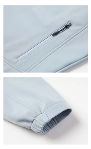 Detail of light blue-grey jacket featuring functional waterproof zipper and elastic cuffs