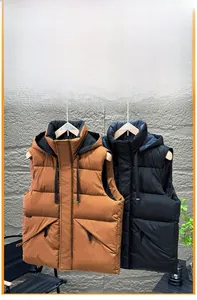 Detail of padded hooded vest featuring removable drawstring hood and zipper pockets