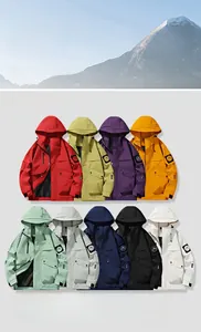 Detail of adjustable velcro cuffs and mountain peak badge on a hooded outdoor jacket
