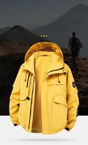 Detail of yellow waterproof outdoor jacket with adjustable cuffs and branded patch