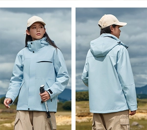 Detail view of light blue outdoor jacket showing functional pockets and waterproof hood design