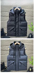 Close-up of a black hooded vest featuring a drawstring hood and windproof fabric details
