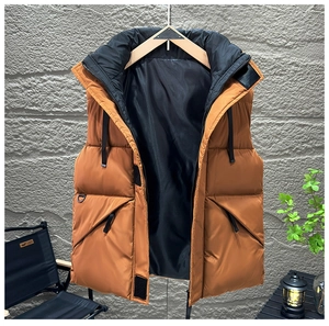 Detail of brown quilted vest with high collar and dual zipper closure on wooden hanger