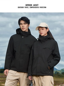 Close-up of black hooded outdoor jacket with windproof high collar and adjustable cuffs
