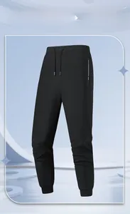 Detail of black quick-dry jogger pants with elastic drawstring waist and zippered pocket