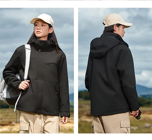 Detail of black hooded outdoor jacket featuring windproof fabric and functional pockets