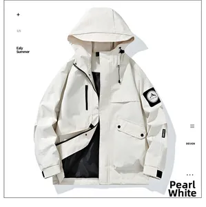 Detail of pearl white hooded windbreaker featuring utility pockets and mountain sleeve patch