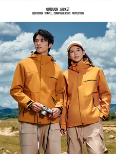 Close-up of bright yellow outdoor jacket with waterproof fabric and hood detail