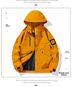 Detail of maple yellow hooded jacket with waterproof fabric and mountain patch on sleeve