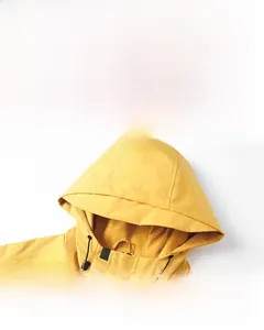 Detail of waterproof outdoor yellow jacket featuring a windproof adjustable hood with drawstrings