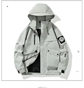 Detail of light grey outdoor jacket featuring multi-pocket design and mountain sleeve patch