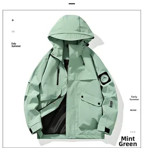 Detail of emerald green jacket showing drawstring hood and chest zipper pocket
