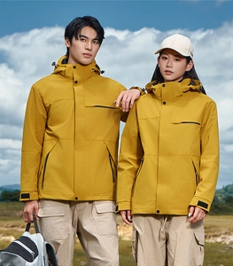 Detail view of a bright yellow hooded outdoor jacket featuring adjustable velcro cuffs