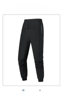 Detail of black ice silk joggers featuring elastic drawstring waist and silver zipper pocket