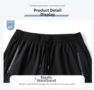 Detail of men's black quick-dry pants featuring elastic waist and zipper pockets