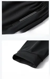 Detail of high-elastic black ice silk pants showing zip pocket and elastic ribbed cuffs