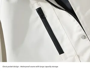 Detailed close-up of white outdoor jacket showing waterproof zipper and metal snap button