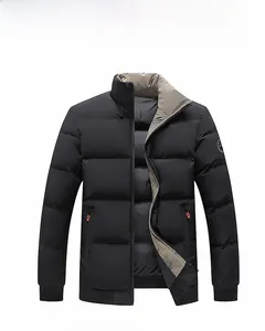 Detail of black quilted winter jacket featuring orange zipper accents and stand collar