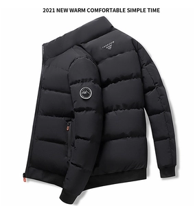 Detailed view of black quilted jacket with standing collar and orange zipper pockets