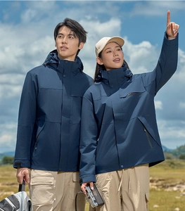 Close-up of deep blue waterproof fabric texture and zipper pocket on outdoor jacket