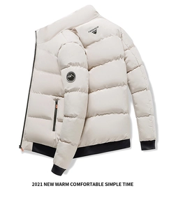 Detailed view of cream puffer jacket featuring brand arm patch and ribbed elastic cuffs