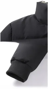 Detail of windproof black padded jacket featuring elastic ribbed cuffs and smooth shoulder seams