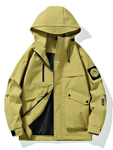 Men's mustard yellow hooded utility windbreaker jacket with arm patch on white background