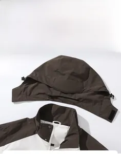 Detail of outdoor windproof jacket showing detachable drawstring hood and mesh lining