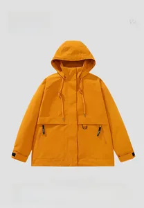 Detail of an orange outdoor hooded jacket with zippered pockets and adjustable cuffs