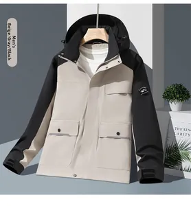 Detail of outdoor windproof hooded jacket in beige and black with utility pockets