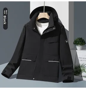 Detail of black hooded jacket with multiple cargo pockets and mountain patch on sleeve