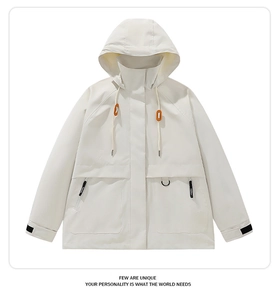 Detail view of white windbreaker jacket showing orange hood drawstrings and zipper pockets