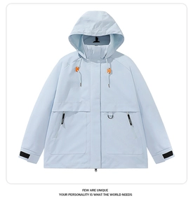 Detail of light blue windbreaker showing adjustable cuffs and large utility pockets