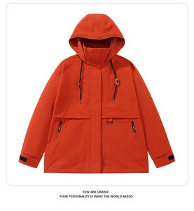 Close-up of bright red windbreaker jacket with adjustable hood and zipper pocket detail