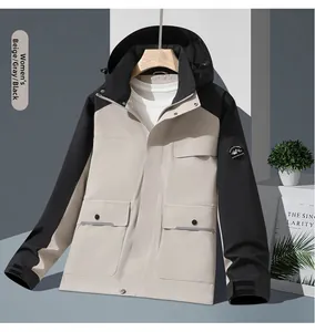 Detail of outdoor hooded jacket with drawstring hood and flap pocket in beige and black
