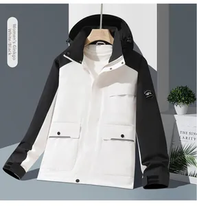 Detail of female white and black waterproof jacket showing zipper and large utility pockets