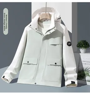 Detail of outdoor hooded jacket with mountain patch and functional cargo pockets