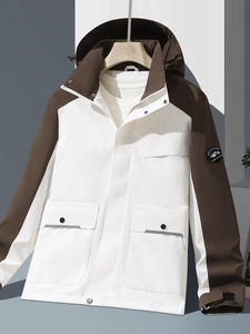 Outdoor mountain jacket in white and brown patchwork with hood and large utility pockets